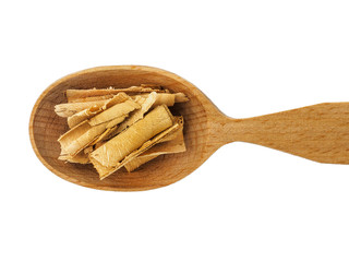 Dry rosehip bark in a wooden spoon on a white background