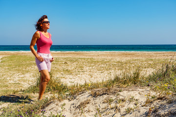 Woman walking on beach, Spain