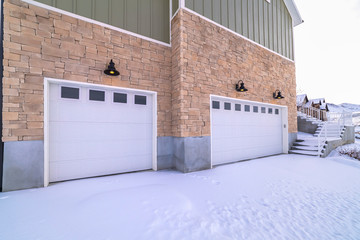 Snow covered forecourt with double garage doors © Jason