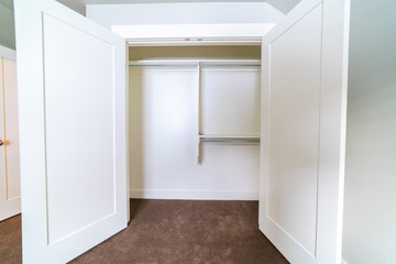 Empty interior of an open white closet