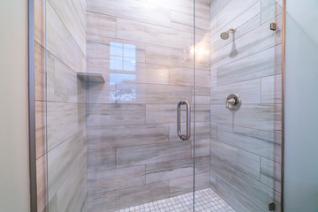 Large modern tiled shower cubicle bright interior