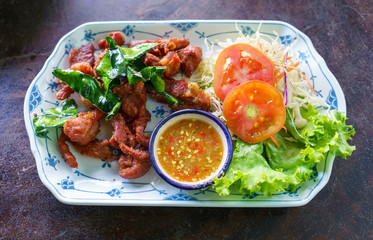 Deep fried dried pork with crispy leech lime , salad and spicy sauce