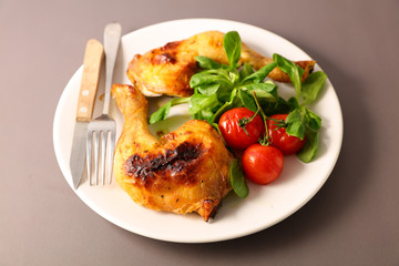 grilled chicken leg and salad in plate