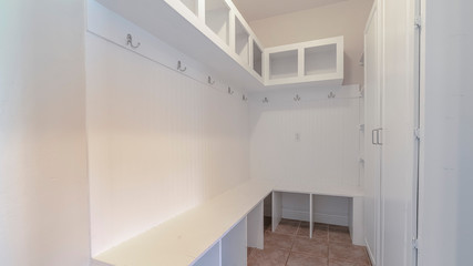 Panorama Interior of a narrow white room with empty shelves