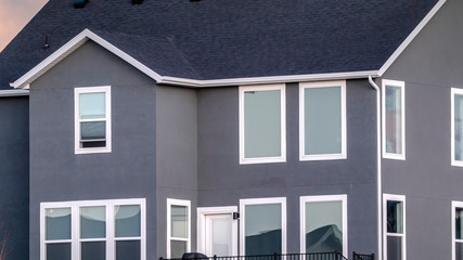 Panorama Grey double storey house against stormy clouds