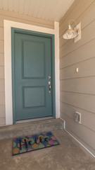 Vertical Recessed covered front door with Hello welcome mat