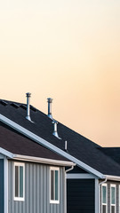 Vertical frame Roofs of modern urban houses at sunset