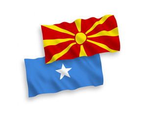 National vector fabric wave flags of Somalia and North Macedonia isolated on white background. 1 to 2 proportion.