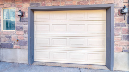 Panorama frame Automated garage door of a brick house
