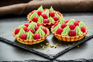 Delicious raspberry mini tarts tartlets with whipped cream