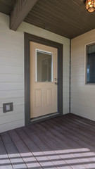 Vertical Wooden deck in front of a front door to a home