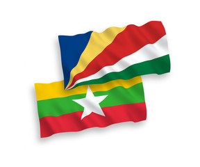 National vector fabric wave flags of Seychelles and Myanmar isolated on white background. 1 to 2 proportion.