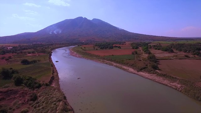 A drone shot of Mt. Arayat in Pampanga, Philippines, and the Arayat River, showing the beautiful province.