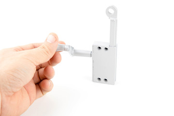 The hand is holding handle of Gray Aluminium Window winder Operator for rotating glass window isolated on white background.