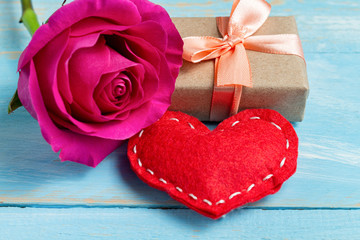 Present gift box, flower and heart for Valentine day on the blue background