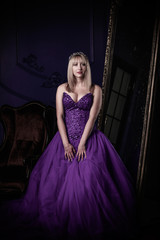 Mystical woman in violet vintage evening dress, fashionable concept