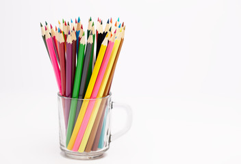 Colorful wooden pencils stand in a pencil holder