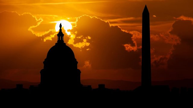 Iconic Monuments in Washington, Sunset with Red Sun and Fiery Clouds, USA