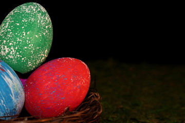beautiful multicolored Easter eggs in a wicker basket 