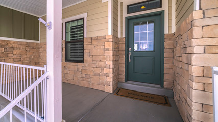 Panorama frame Covered cement patio with wooden front door