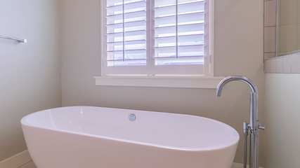 Panorama Freestanding white oval tub in a modern bathroom