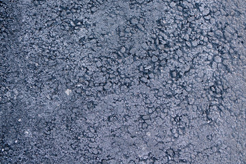 texture of the frozen asphalt. frost on the asphalt as a background