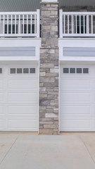 Vertical Two single garages sharing a cement driveway