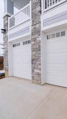 Vertical frame White garage doors overlooking winter snow day light