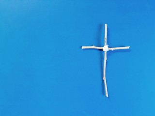 a wooden cross on blue background
