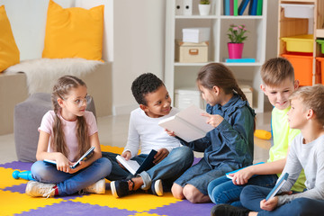 Cute little children reading books indoors