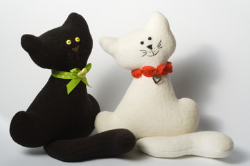 two toys of cat couple, black and white, white background