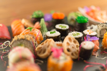 Japanese sushi on table, blurred view, mixed products