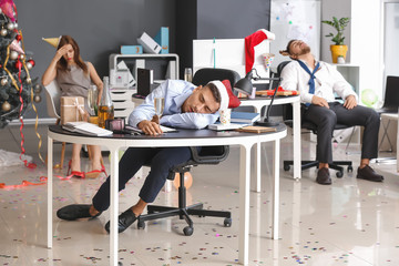 Young people with hangover after New Year party in office