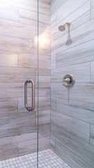 Vertical frame Large modern tiled shower cubicle bright interior