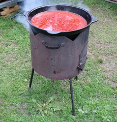 Large cauldron with delicious kharcho soup cooked on a picnic in the forest