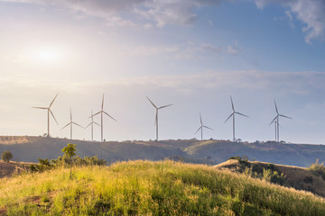 Wind turbines farm on mountanis landscape against blue sky with clouds background,Windmills for electric power ecology concept