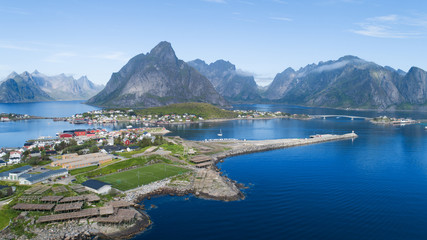 Aerial view of Reine, Lofoten islands, Norway. The fishing village of Reine. Summer time in Nordland. Blue sky. Travel concept.