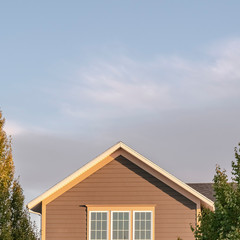 Square Facade of a brown timber clad urban house