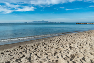 View to natural beach with mole.