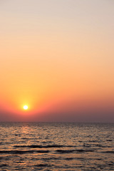 Beautiful burning yellow sunset at Jomtien beach Pattaya Thailand with silhouettes in the foreground 