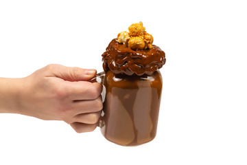 Chocolate milkshake with whipped cream, cookies, waffles, served in glass mason jar. 