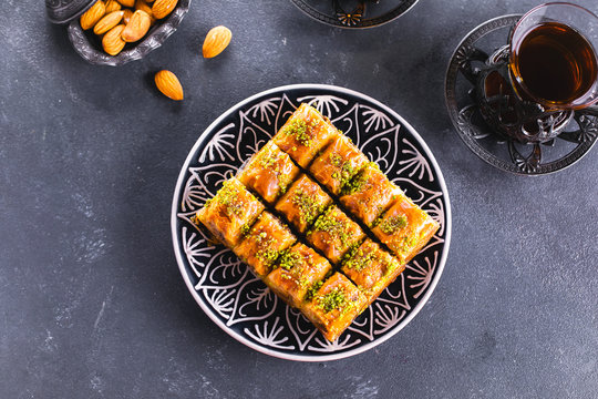 Baklava. Ramadan Dessert. Traditional Arabic Dessert With Nuts And Honey, Cup Of Tea On A Concrete Table. Top View