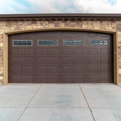 Square Large garage with double brown wooden door
