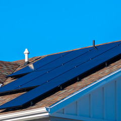 Square frame Snow and photovoltaic solar panels on a roof
