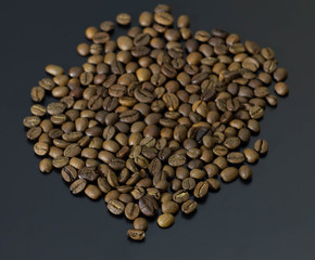 pile of coffee beans isolated on gray background