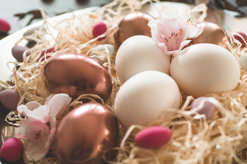 Happy Easter. Congratulatory easter background. Easter eggs on a metal plate with spring flowers on...