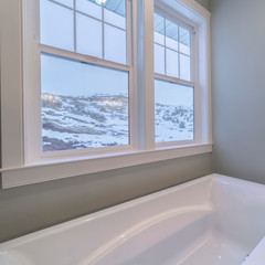 Square View from a bath tub of a snowy winter landscape