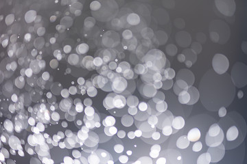 Abstract bokeh from light and water spray in backgrounds of various colors