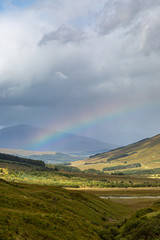 Obraz premium A Rainbow and Mountains in Scotland on a September Day
