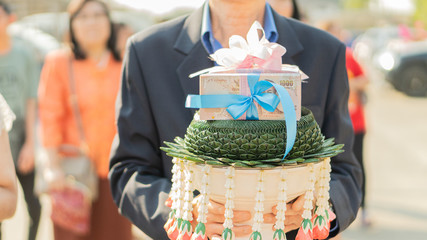 A large amount of dowry on the tray, which is the Thai money that the bridegroom father asked for...